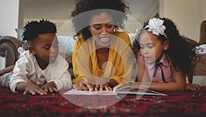 African American mother with her cute children lying on floor and reading a storybook