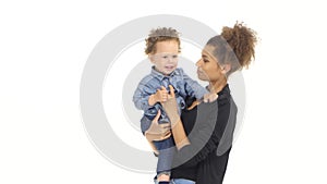 African american mother is holding a child and playing with it. White background