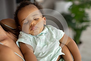 African American mother holding her sleeping son