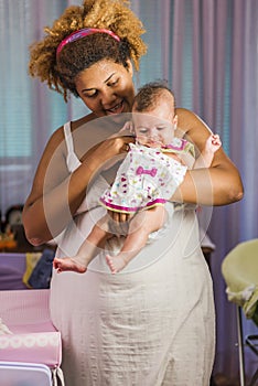 African american mother hugging her baby
