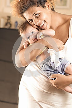 African american mother hugging her baby