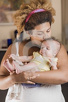 African american mother hugging her baby