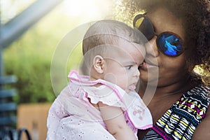 African american mother kisses baby