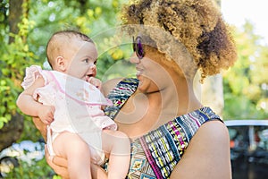 African american mother kisses baby