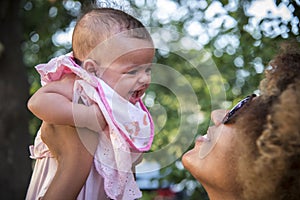 African american mother kisses baby