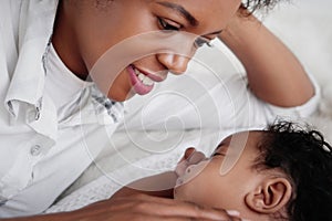 African american mother looking at her ainfant baby son with love