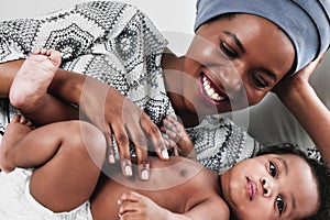 African american mother looking at her ainfant baby son with love