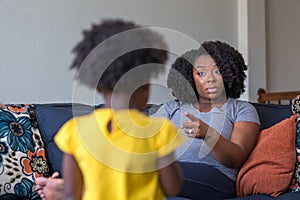 African American mother disciplining parenting her young child. photo