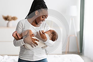 African American mother singing lullaby for infant to sleep