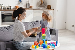 African american nanny touching hand of