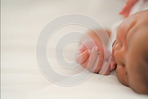 African american new born baby hand on white bed