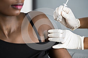 African American Nurse Making Covid-19 Vaccine Injection