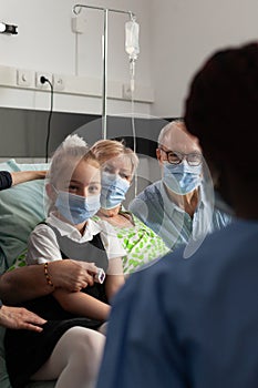 African american nurse monitoring elderly senior woman after clinical surgery