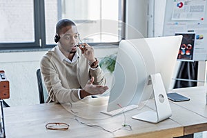 african american operator holding microphone while