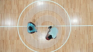 African-american opponents are playing basketball in a top view