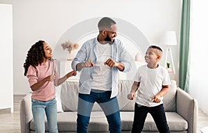 African american parent dancing to music with little children