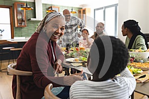 African american parents, children and grandparents celebrating at thanksgiving dinner