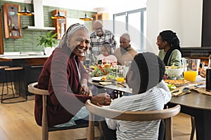 African american parents, children and grandparents celebrating at thanksgiving dinner