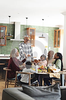 African american parents, children and grandparents celebrating at thanksgiving dinner