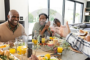 African american parents, children and grandparents celebrating at thanksgiving dinner, slow motion