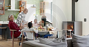 African american parents, children and grandparents celebrating at thanksgiving dinner, slow motion