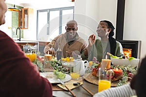 African american parents and grandparents celebrating at thanksgiving dinner, slow motion