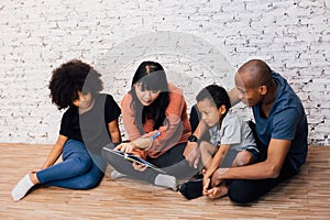 African American parents reading a fairy tale fable story for kiAfrican American parents reading a fairy tale fable story for kids