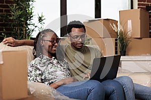 African american partners finding furniture on online website