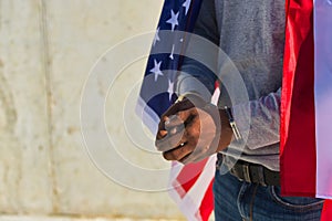 African american person with shackles in his hands and united states flag over his shoulders. Racial repression