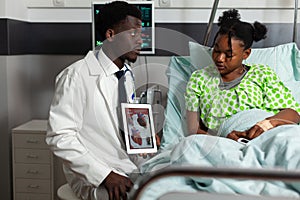 African american physician doctor holding tablet computer explaining heart radiography