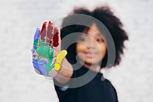 African American playful and creative kid getting hands dirty wi