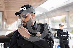 African american police officer talking on