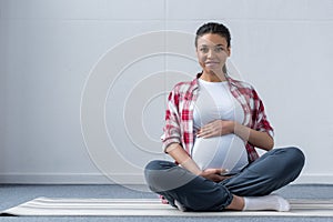 african american pregnant woman sitting
