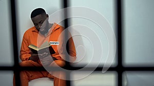 African-american prisoner reading holy bible, convicted sinner, religion photo