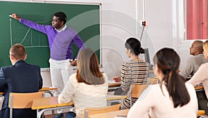 African american professor lecturing to adult students at university