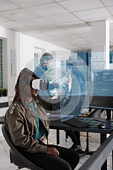 African american programmer writing code and using holographic program