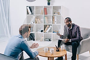 African american psychiatrist talking to young male photo