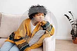 African american sad thoughtful girl at home. Young african woman feels depressed offended lonely upset suffers from