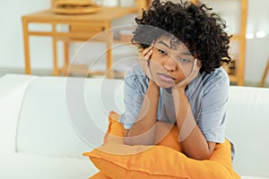 African american sad thoughtful girl at home. Young african woman feels depressed offended lonely upset suffers from