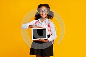 African American Schoolgirl Hodling Tablet Computer With Blank Screen