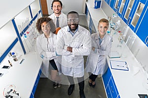 African American Scientist With Group Of Researchers In Modern Laboratory Happy Smiling, Mix Race Team Of Scientific