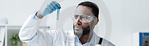 African american scientist in safety goggles