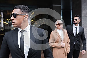african american security man in sunglasses photo