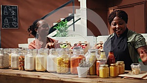 African american seller giving food sample to customer
