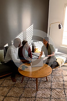 African american senior couple having meeting with asian female financial advisor at home