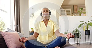 An African American senior woman is meditating at home