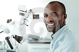 African American short-haired beaming doctor openly smiling