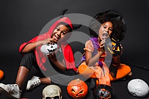 african american siblings in halloween costumes