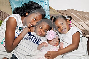 African American Siblings Hugging On Floor