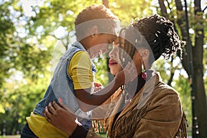 African American single mother in park with her daughter.